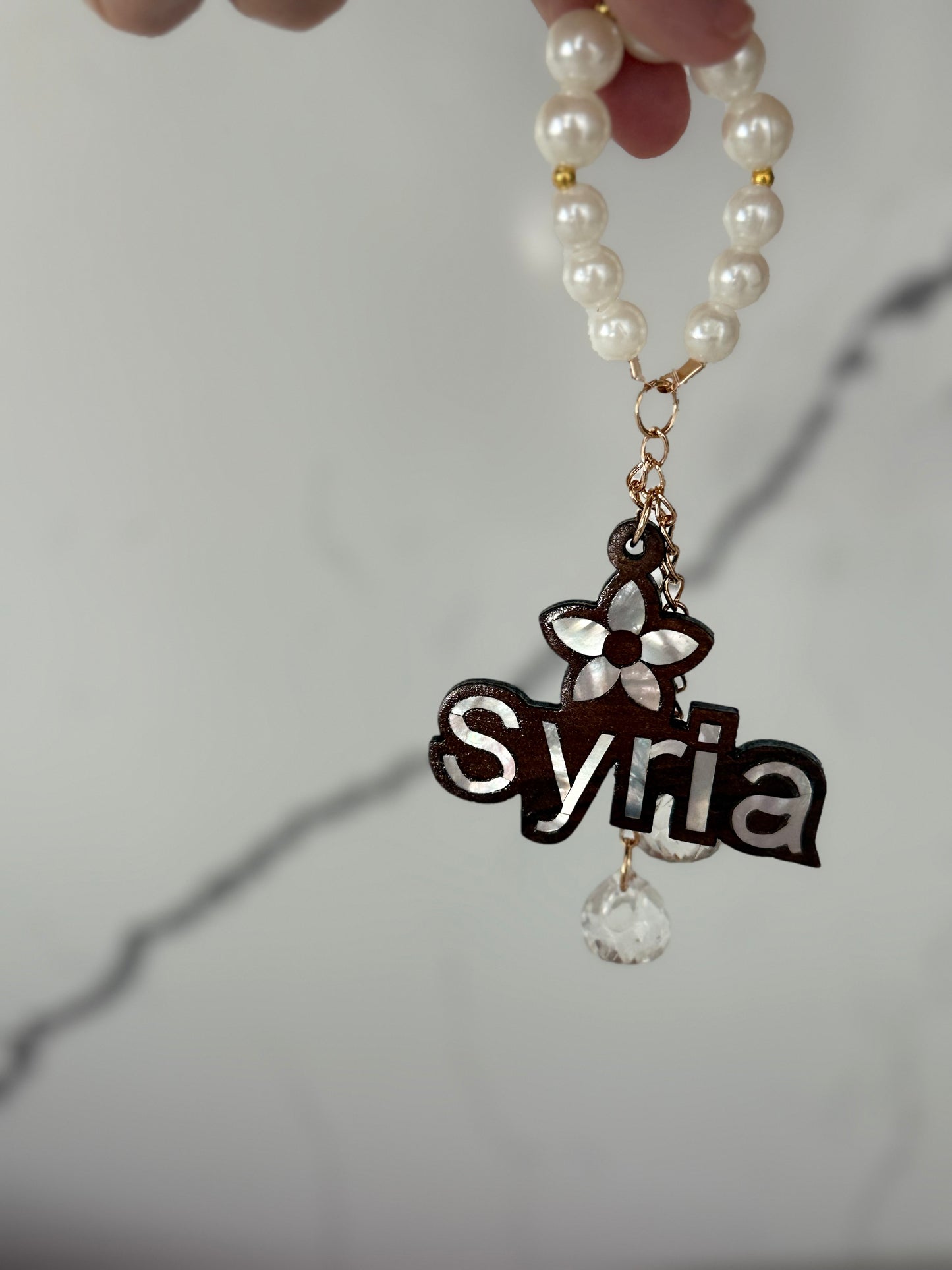 Syria Pearl Charm Keychain.”