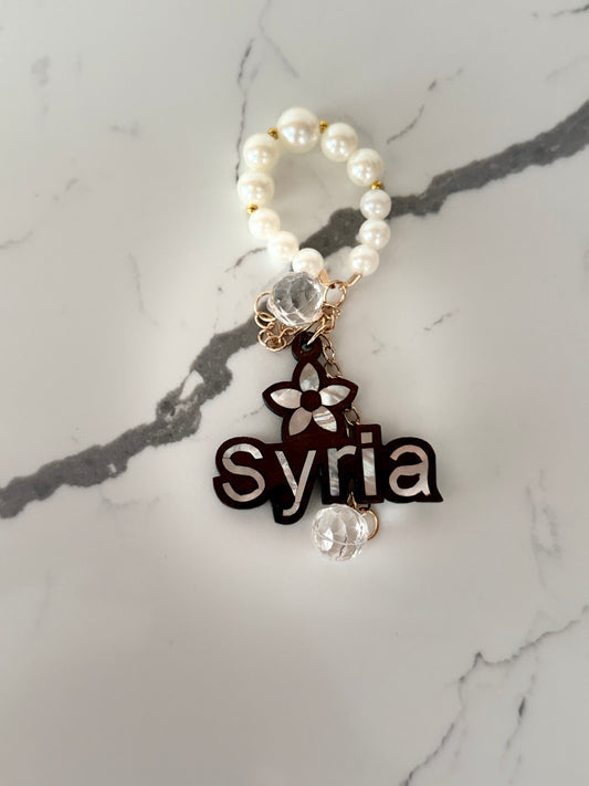 Syria Pearl Charm Keychain.”